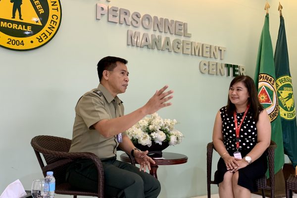 Lt. Col. Eliglen Villaflor discusses the situation of Army retirees to HR Group Manager Jaimie Natividad.